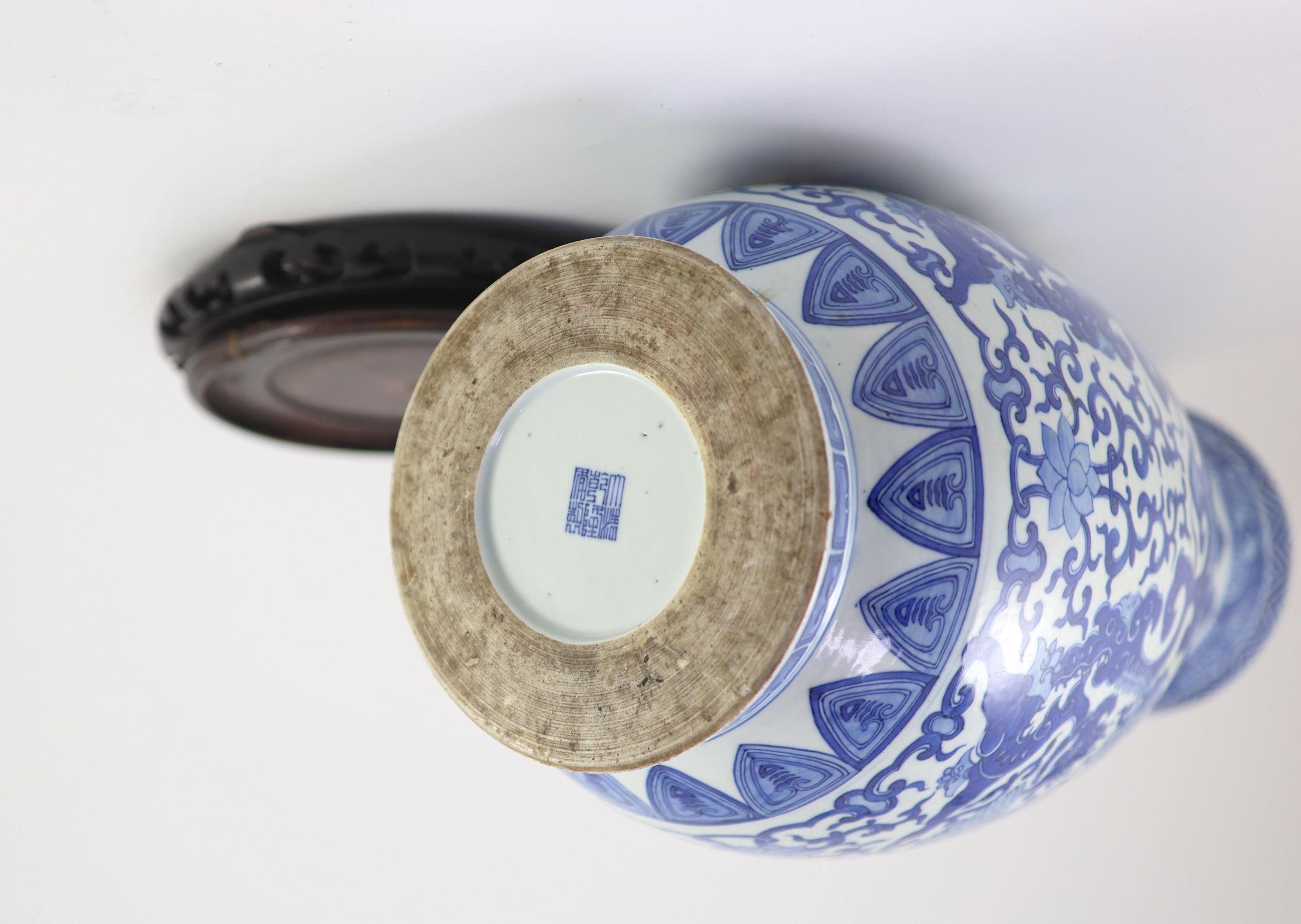 A Chinese archaistic blue and white pear-shaped vase, Qianlong mark but 19th century, 44.5 cm high, wood stand